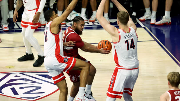 Feb 4, 2024; Tucson, Arizona, USA; Stanford Cardinal guard Jared Bynum (1) drives to the basket against Arizona Wildcats forward Keshad Johnson (16) and center Motiejus Krivas (14) during the first half at McKale Center. Mandatory Credit: Zachary BonDurant-USA TODAY Sports